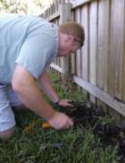 a Centreville Sprinkler pro fills in the space around a newly installed pop up head